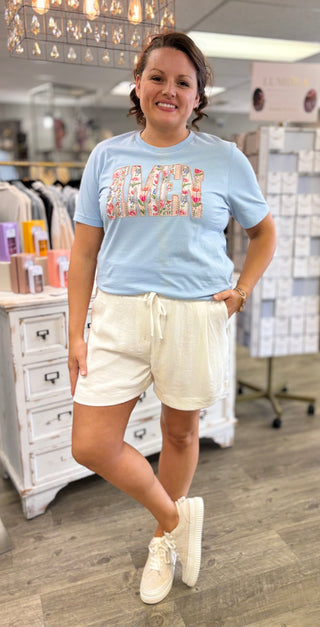 Model wearing blue shirt that says ‘AMEN’