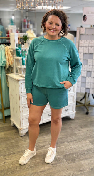 Woman wearing a teal outfit in a store setting