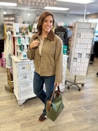 Woman wearing the Hay There taupe corduroy barn jacket with a chocolate brown corduroy collar, styled with a cream top, dark jeans, brown sneakers and an olive tote