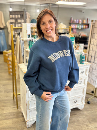 Side view of the dark blue Midwest Cozy Sweatshirt showing the relaxed fit and ribbed cuffs