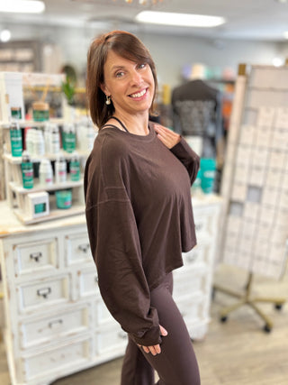 Model wearing a brown long sleeve top with brown leggings
