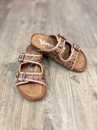 Pair of brown tooled sandals with double straps and buckle details