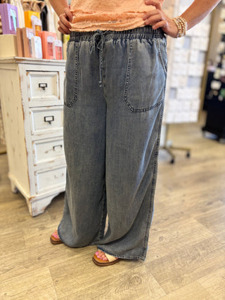 Person wearing wide-leg jeans in a store setting