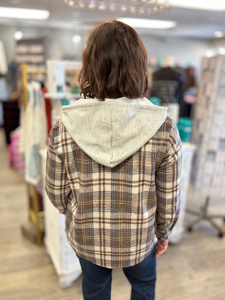 Model brown, cream , and blue shacket with hood and jeans