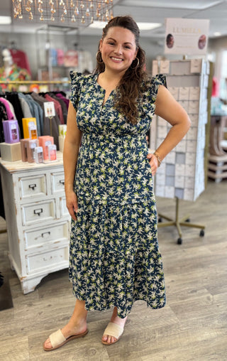 Woman wearing a floral dress in a store setting