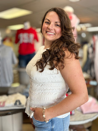 Model wearing white smocked tank top