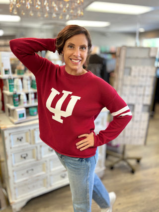 Woman wearing the Indiana Hoosiers crimson long sleeve sweater with the IU logo on the front, a crew neckline and a slightly relaxed fit