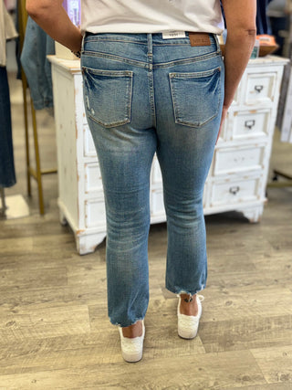 Person wearing blue jeans in a store setting