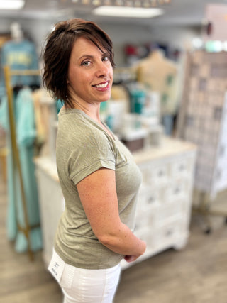 Model wearing olive green top