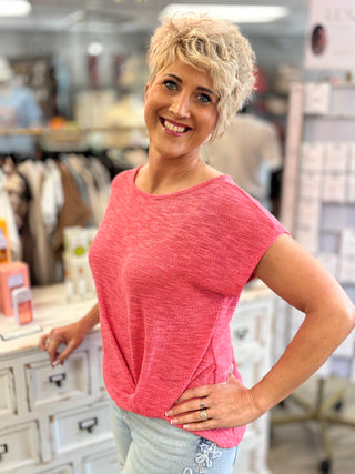 Woman wearing a pink shirt in a store setting
