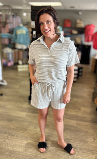 Model wearing grey and white striped shorts set
