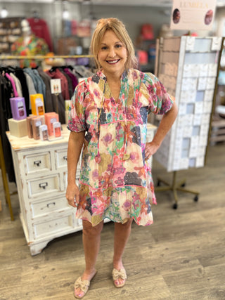 Woman wearing a floral dress in a store setting