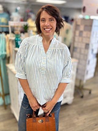 Model wearing blue and white striped top