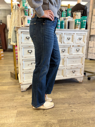 Model wearing dark wash straight leg jeans