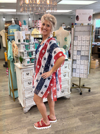 Woman wearing a red, white, and blue kimono with star pattern in a store setting.