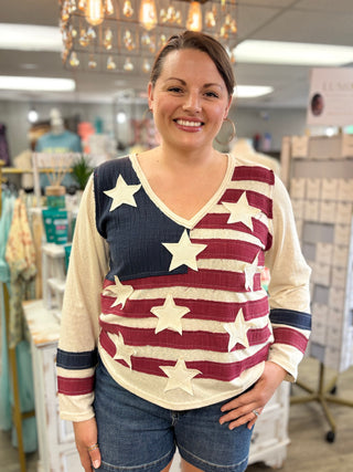 Woman wearing a star-patterned top in a store setting
