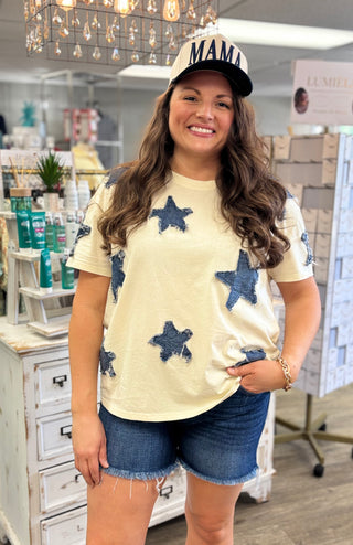 Model wearing cream shirt with denim star appliqué detail