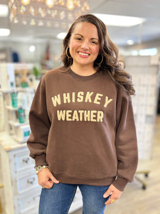 Woman wearing the Whiskey Weather dark brown crew neck sweatshirt with tan lettering - Evergreen Boutique