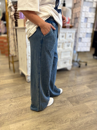 Model wearing blue mineral wash lounge pants with pockets