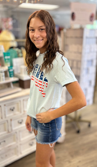 Model wearing light blue LULU MAC t-shirt with American flag detail 