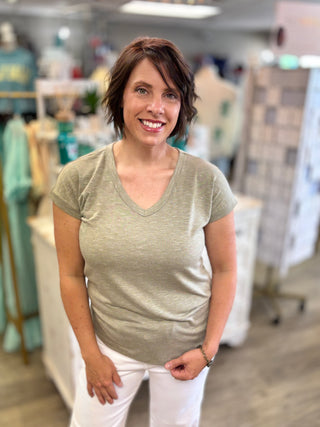 Model wearing olive green top 