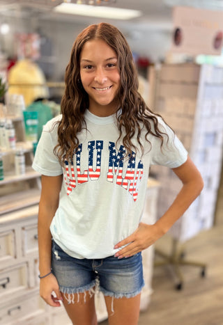 Model wearing light blue LULU MAC t-shirt with American flag detail