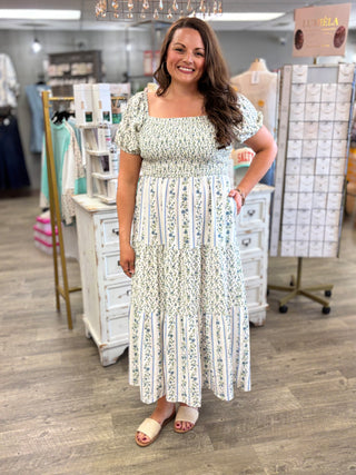 Woman wearing a floral dress in a store setting
