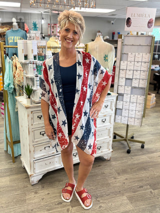 Woman wearing a red, white, and blue patterned kimono in a store setting.
