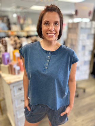 Woman wearing a blue shirt in a store setting