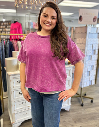 Model wearing acid wash plum tee with denim 