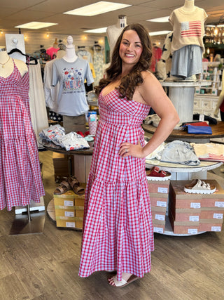 Woman in a red white and blue checkered dress standing in a store