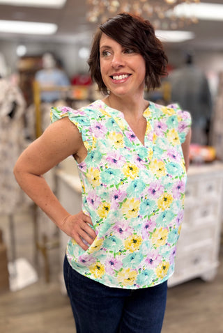 Woman wearing a floral blouse in a store setting