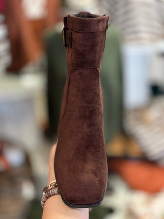 A brown bootie with buckle detail