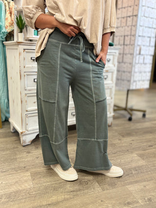 Model wearing ash jade colored lightweight lounge pants with drawstring 
