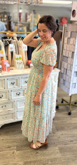 Woman wearing a floral dress in a store setting