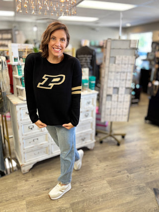 Woman wearing the Purdue Boilermakers black long sleeve sweater with the "P" logo on the front and a crew neckline