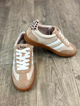 A pair of low-top sneakers in beige suede and cream panels with white laces and white side stripes