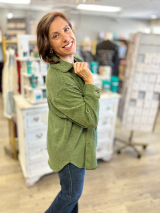 Model wearing a forest green denim shacket and jeans