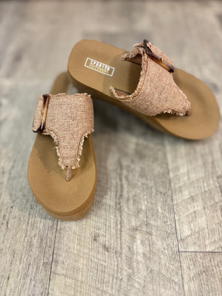 Brown platform flip flops with frayed edges and buckle detail