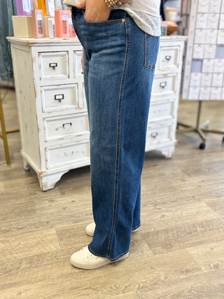 Person wearing blue jeans standing in a store 