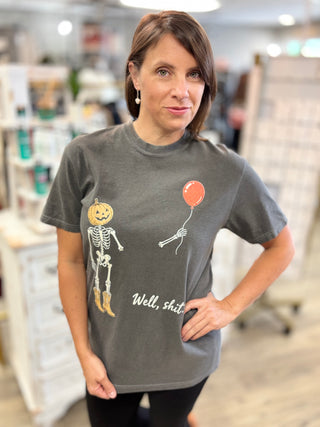 Model wearing a mineral washed black tee shirt with graphic design of cowboy skeleton