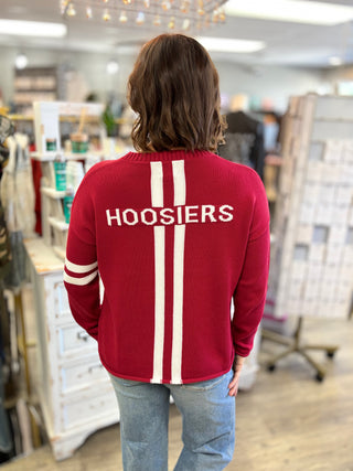 Back view of a woman wearing the crimson Indiana Hoosiers sweater with HOOSIERS across the back