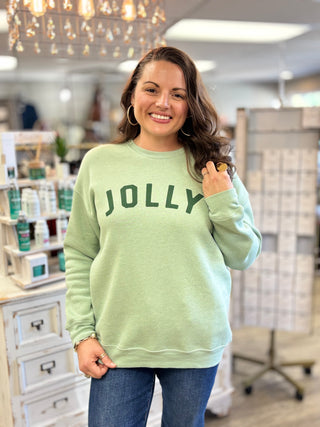 Woman wearing the Jolly graphic sweatshirt in dark heather sage - Evergreen Boutique