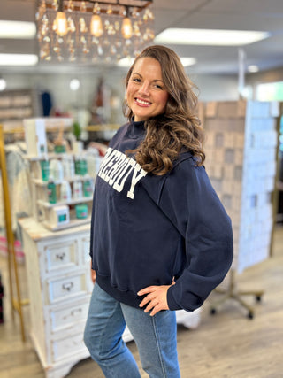 Model wearing navy mock neck sweatshirt with HOMEBOY graphic