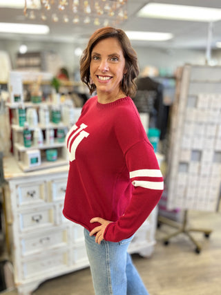 Side view of the women's Indiana Hoosiers crimson cotton sweater showing its long sleeves, medium length and true-to-size fit