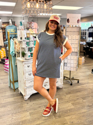 Model wearing navy and white striped dress with pockets