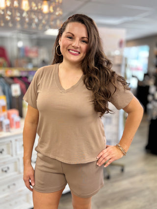 Woman wearing a beige outfit in a store setting