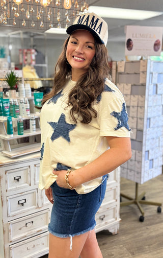 Model wearing cream shirt with denim star appliqué detail
