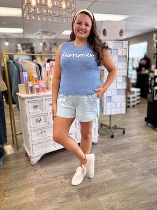 Model wearing blue knitted sweater tank with ‘summer’ embroidered detail