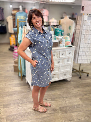 Model wearing short sleeve denim dress with daisy and button down detail